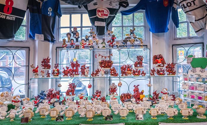 The photo shows a display in the Groggshop complete with red Dragons and sheep with different sayings.